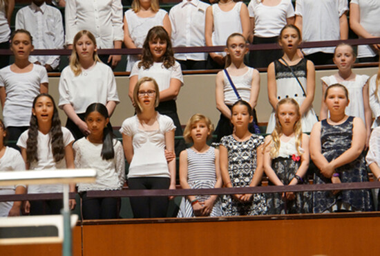 students in a choir singing