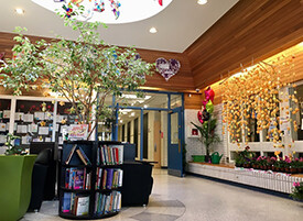 lobby of school with shelf of books in the middle